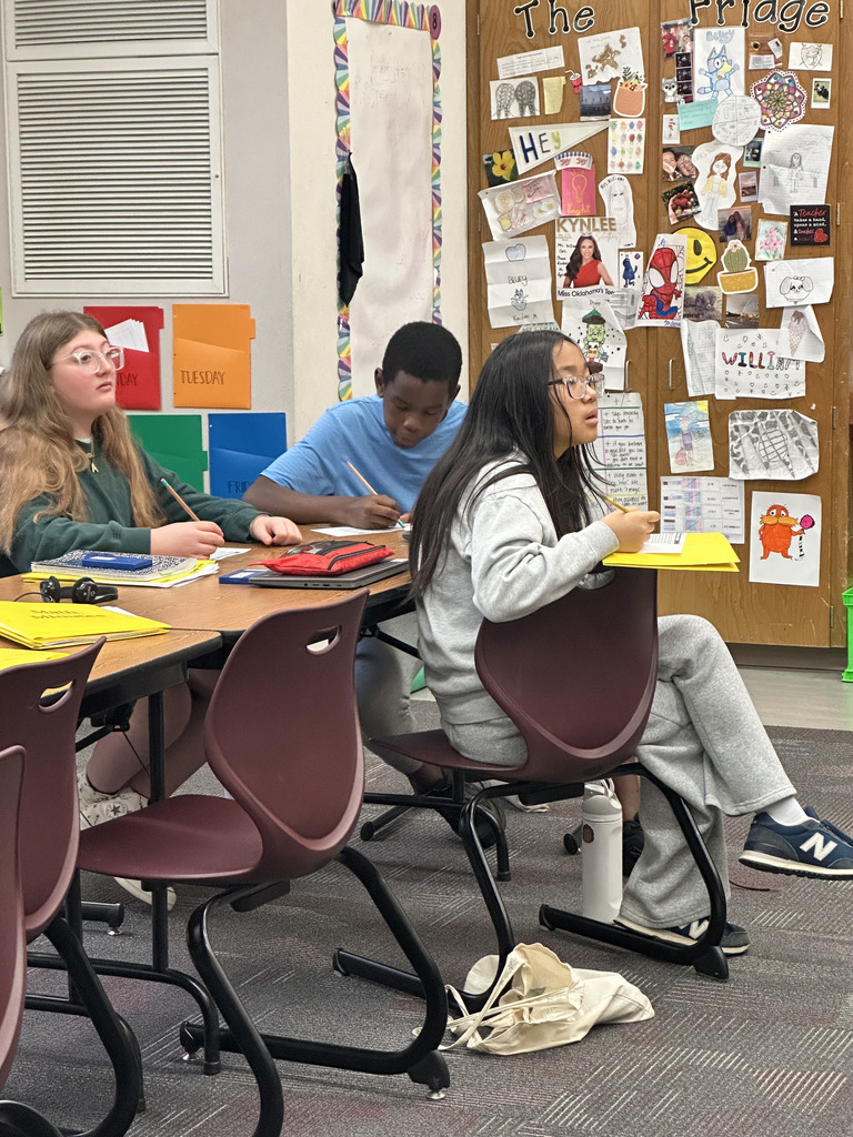 Group of students analyzing data from a basketball game to work on math skills.