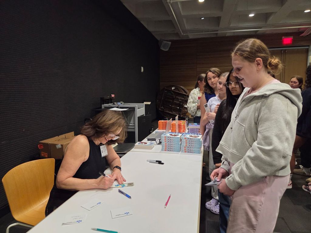 Group of JWI students at the Tulsa Central Library for a field trip- waiting for their books to be signed by the author.