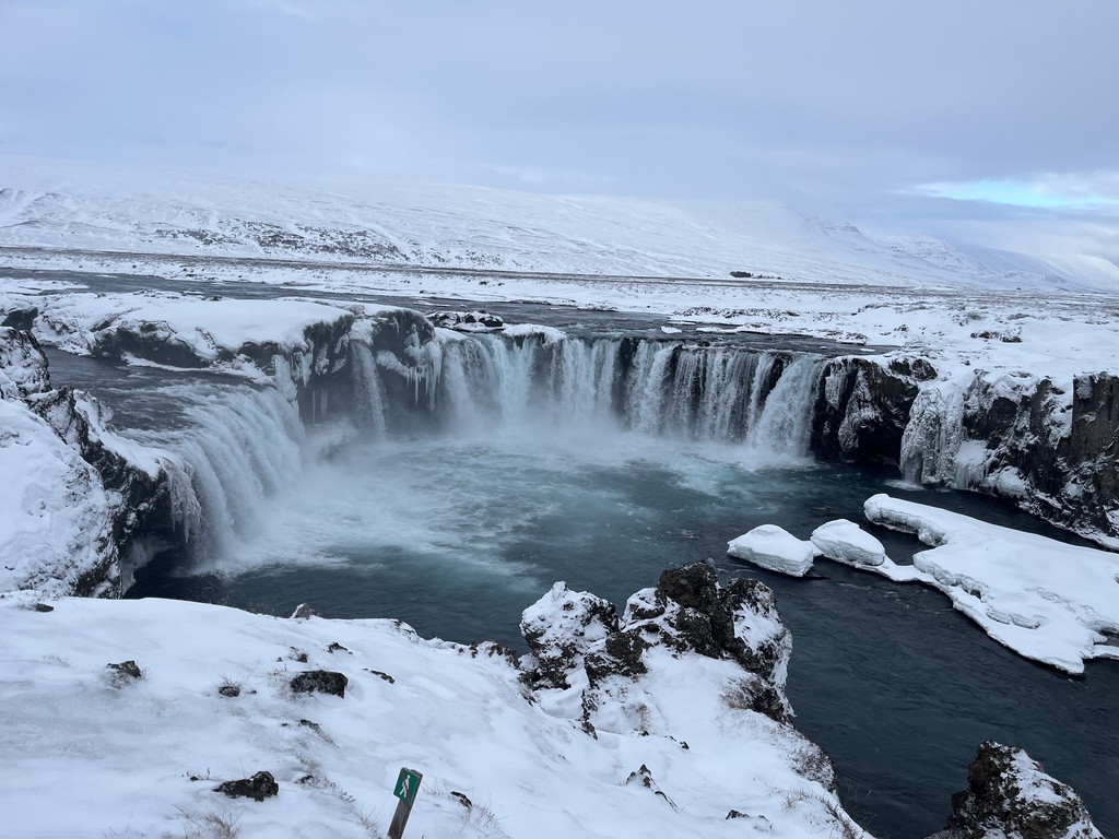 A photo of a view of a waterfall and glaciers.
