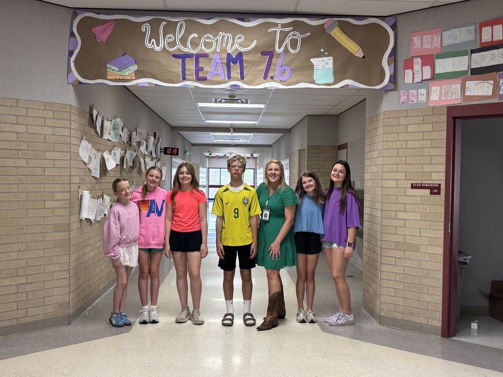 students and teacher dressed in the colors of the rainbow