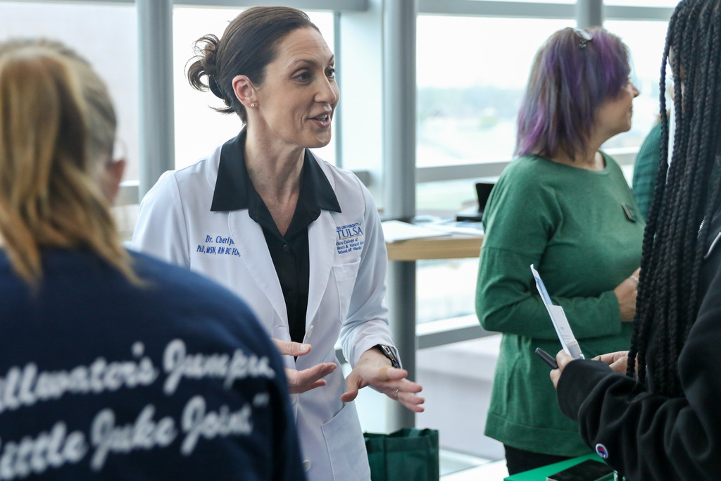 Doctor from the university of tulsa speaking to a student