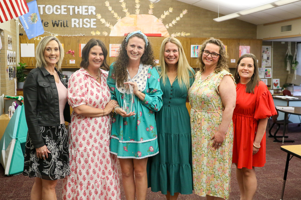 Macy in the center of Jenks West Elementary principals Carla Pugh, Ashley Rubey, Amanda Moore, Courtney Pruner, and Tiffany McAdams.