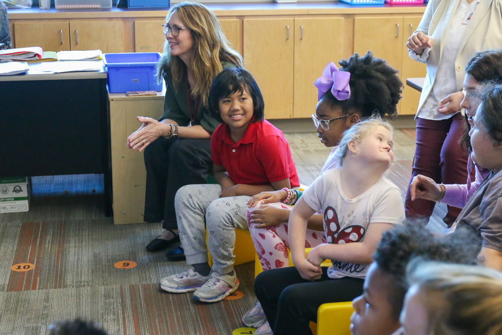 students smiling and laughing with principal ms zemanek next to them.