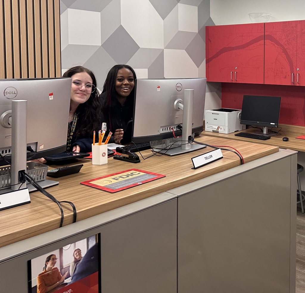 Two students working at a replica bank