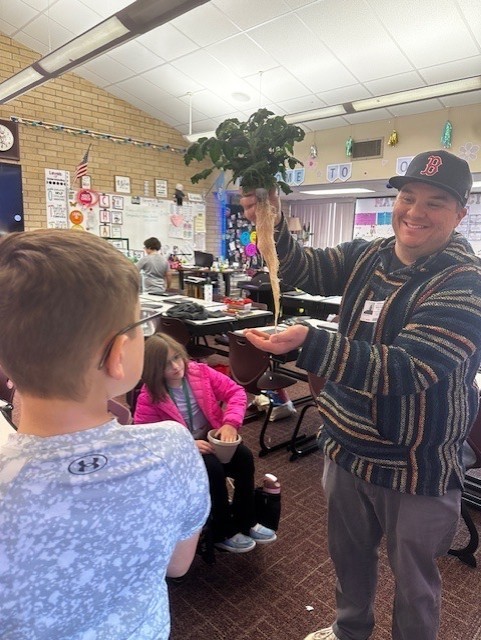 students and volunteer at gardening club