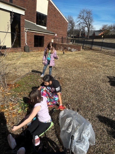 students cleaning during gardening club
