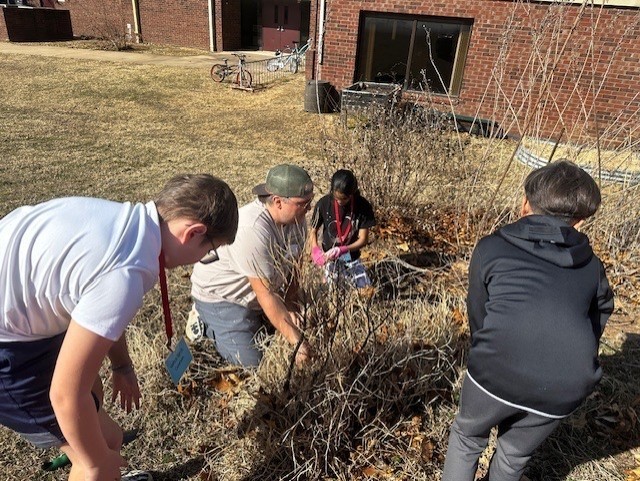 students cleaning during gardening club