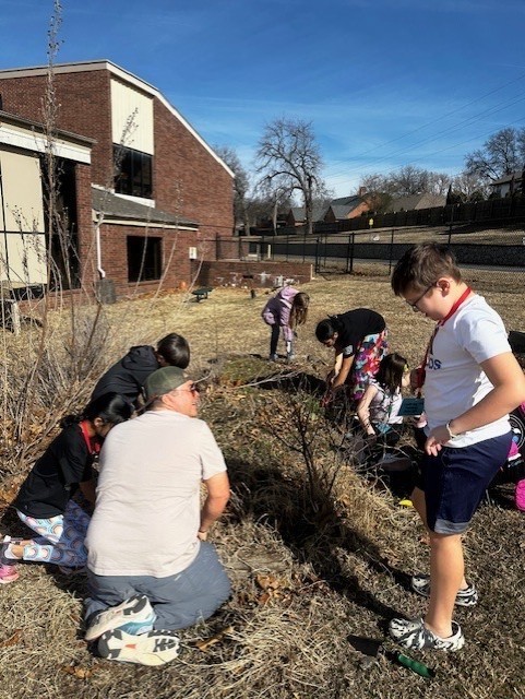 students cleaning during gardening club