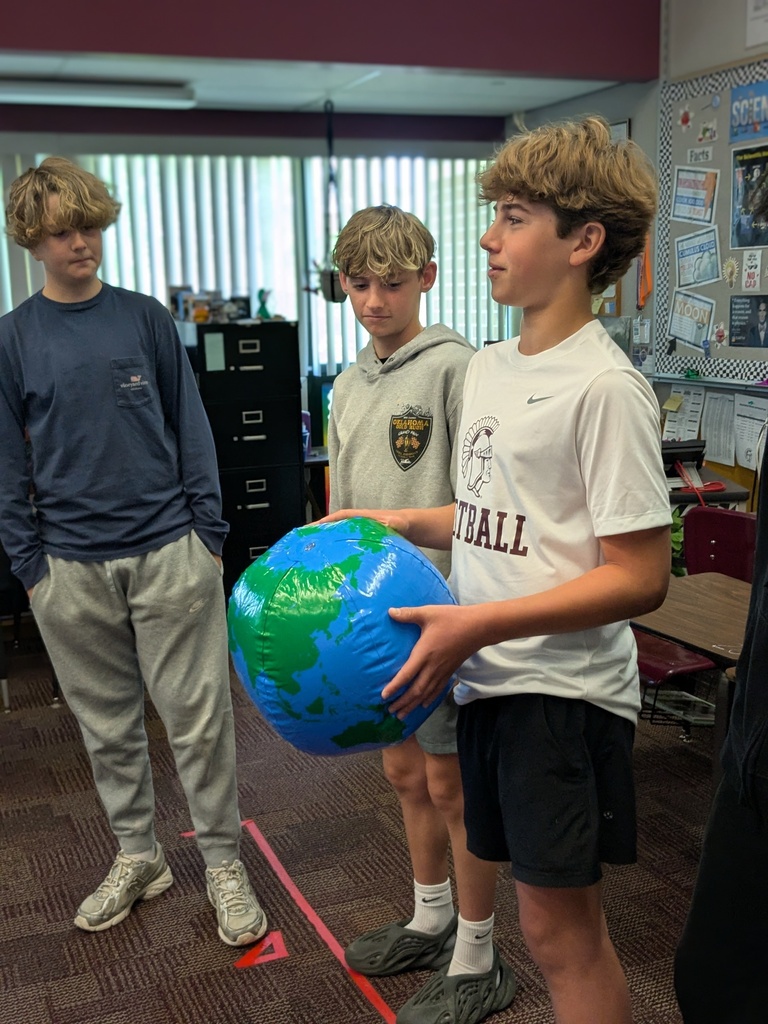 student holding globe ball