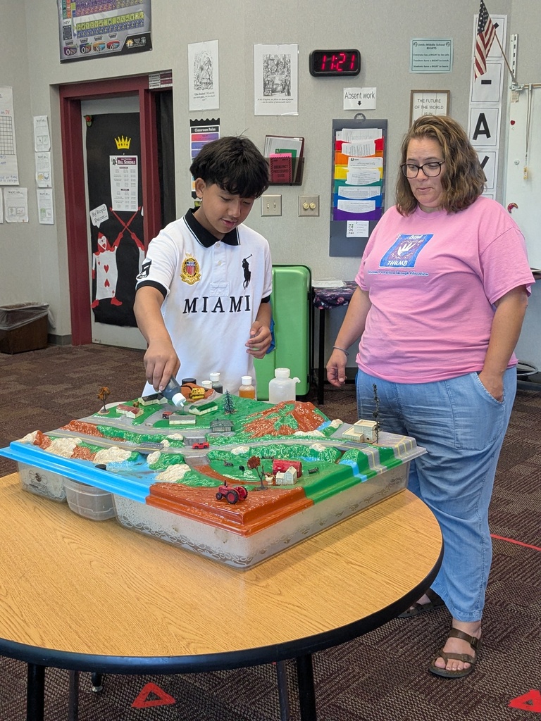 student and teacher working on a science experiment