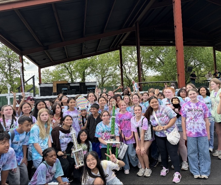 orchestra students with trophy