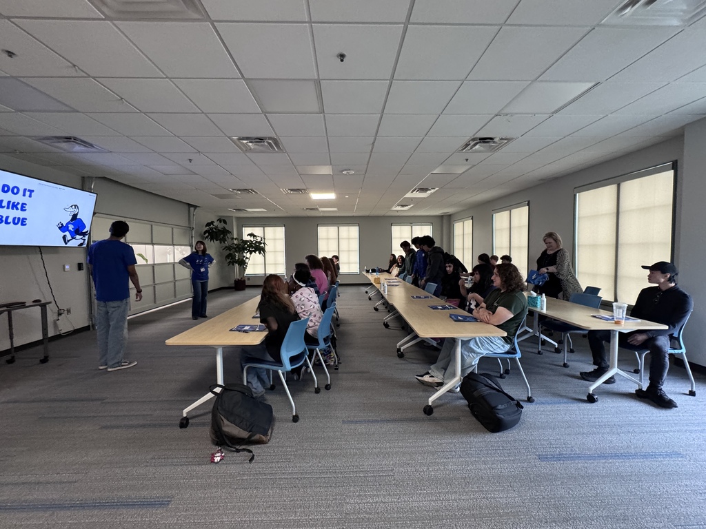 a classroom setting with students watching a presentation