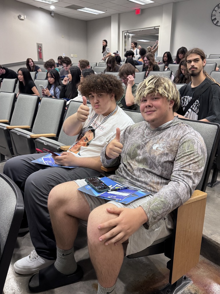 two students giving thumbs up