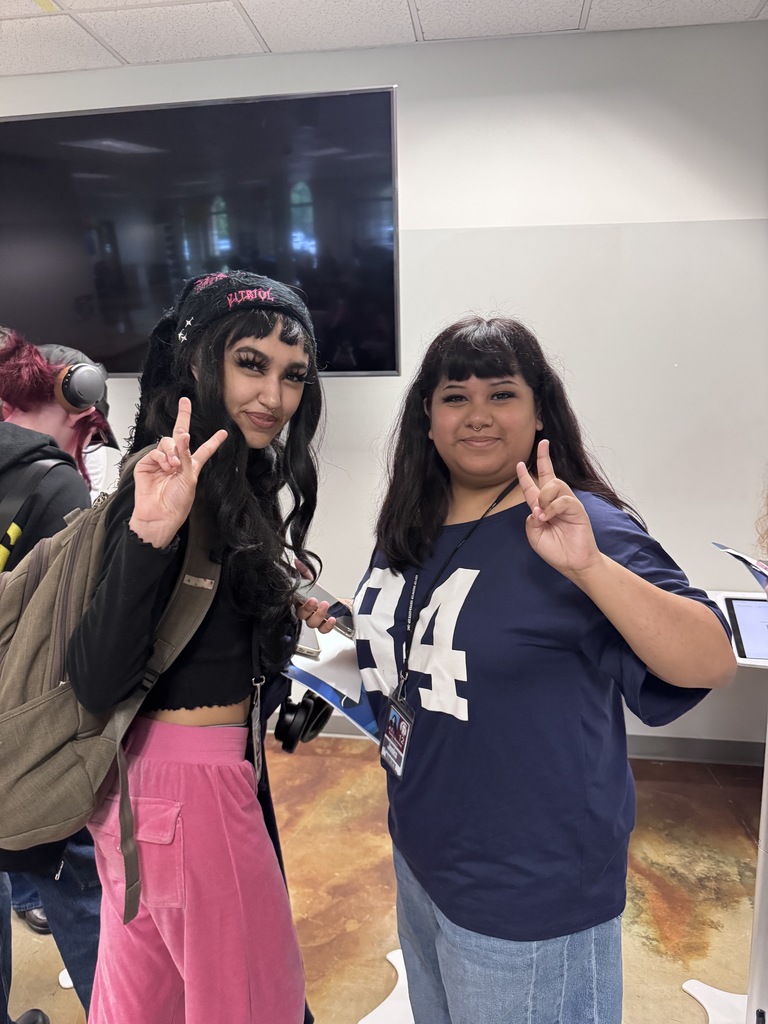two students giving peace signs