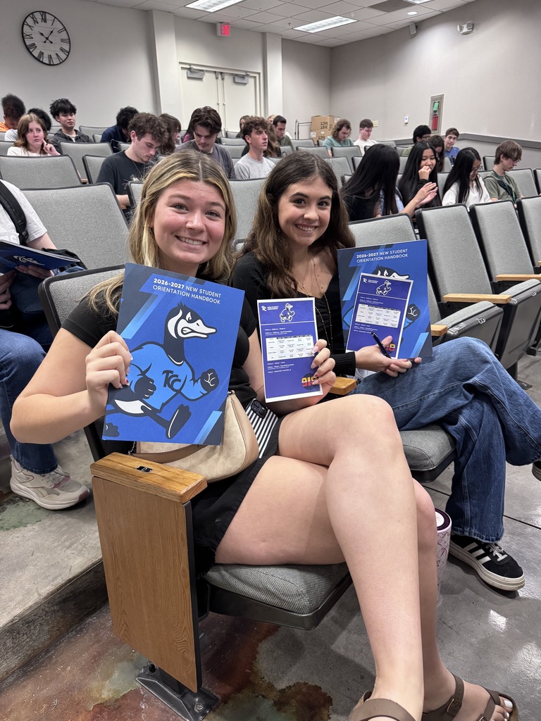 two  students displaying their TCC enrollment materials
