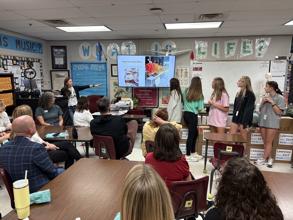 Freshman Academy students and teacher talking during a slide show presentation about a recent trip to Costa Rica