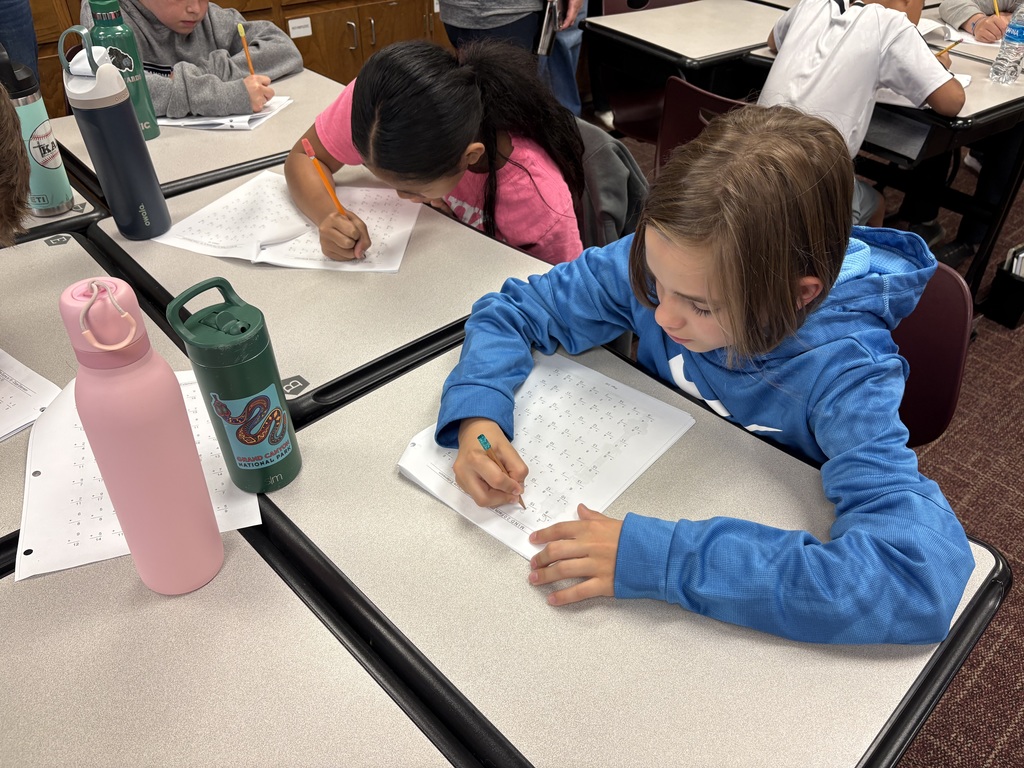 Students at desks working on math problems