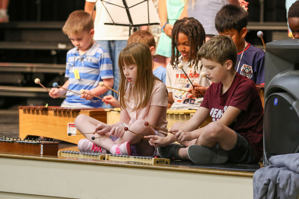 6 students using a xylophones