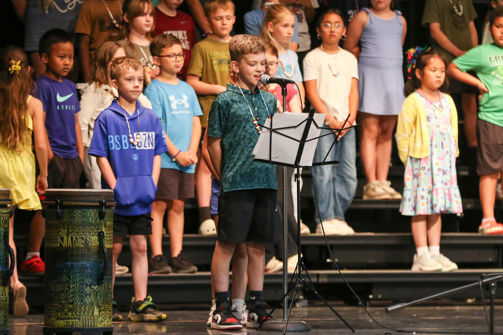 student reading a script into a microphone