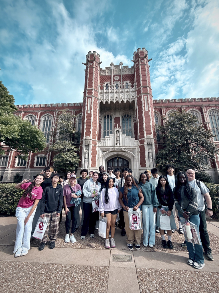 Group of Jenks High School AVID students posing in front of historic building on the campus of the University of Oklahoma