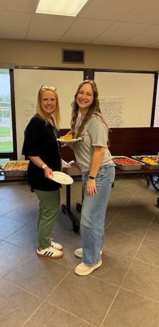 ladies posing with coffee and breakfast