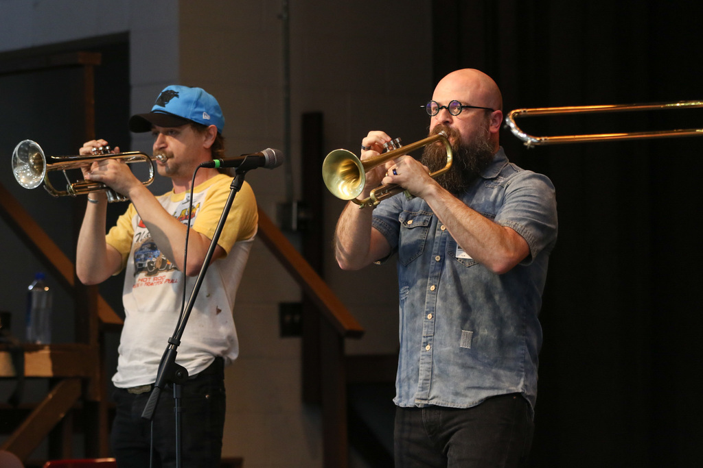 Two members playing their trumpets