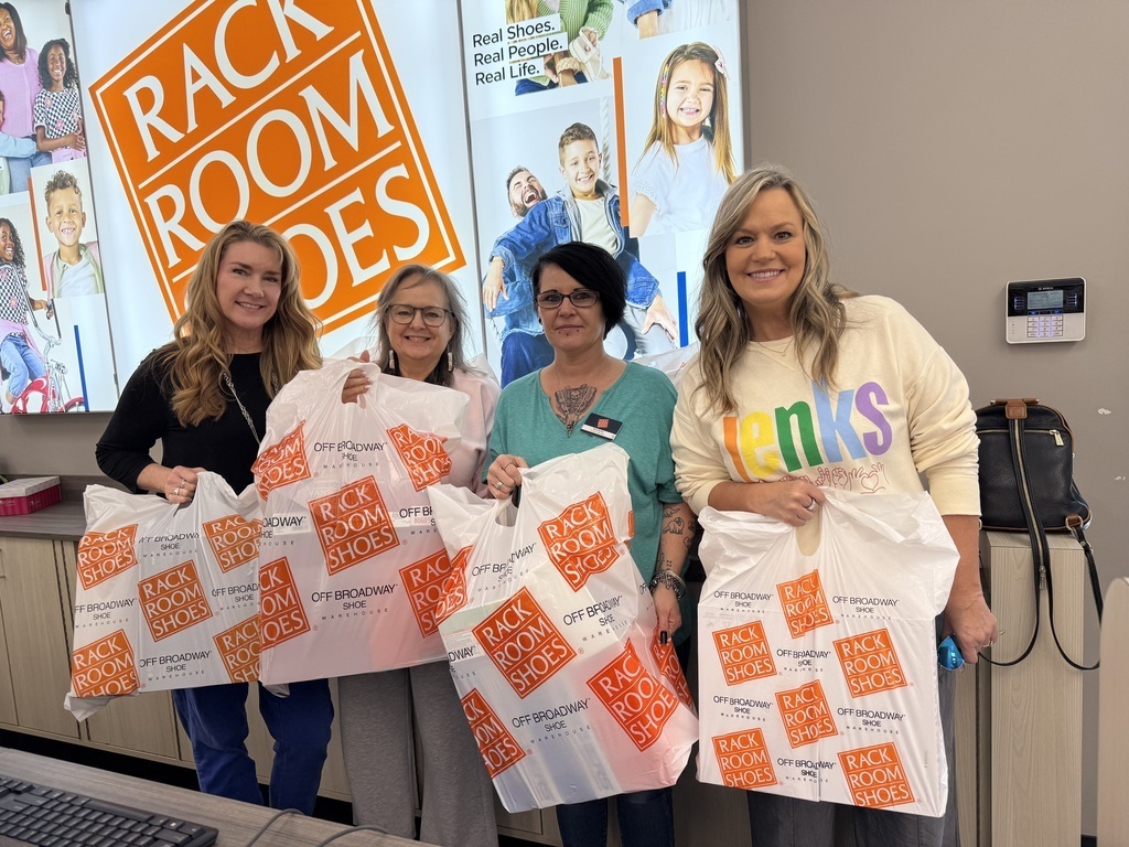 Photo of school counselors with a Rack Room employee, picking up shoes for JEE students.