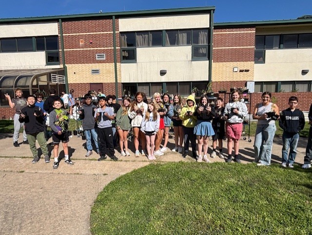 students holding their plants