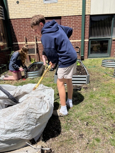 student tending a garden