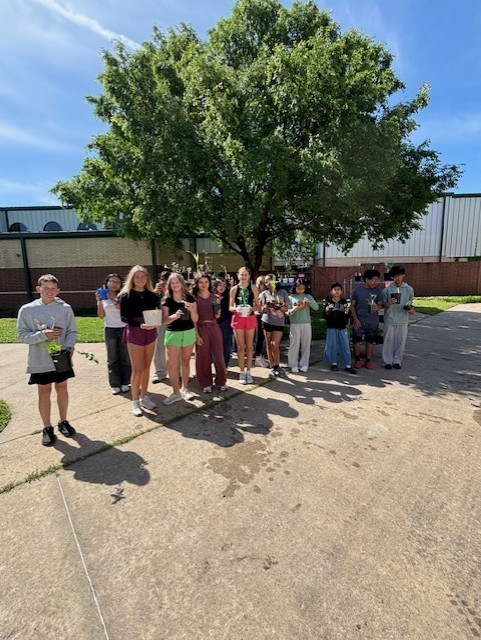 students holding their plants