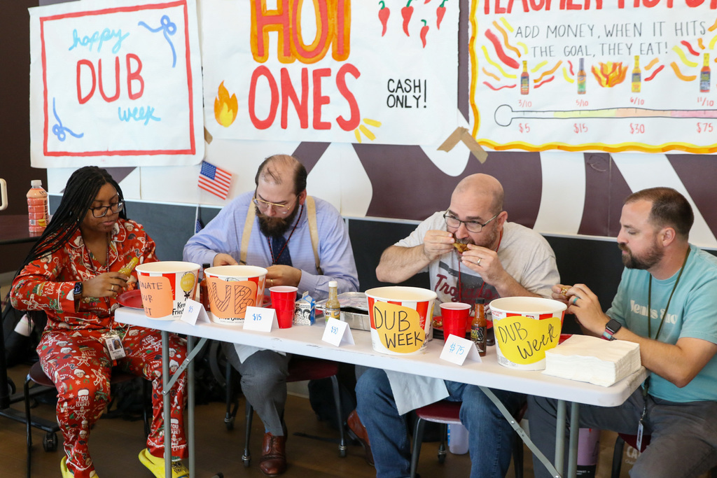 four teachers eating wings during the hot ones challenge