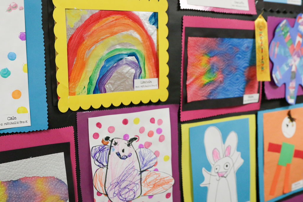 photo of artwork on the wall. rainbows and butterflies