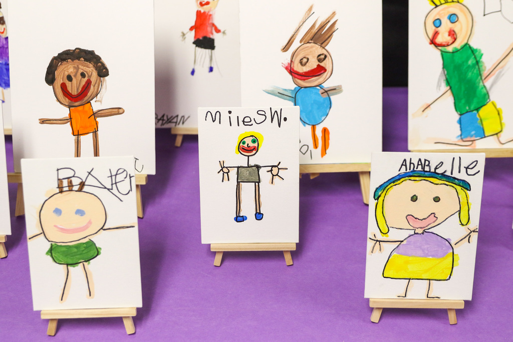 photo of small self portraits of the students on little easels. 