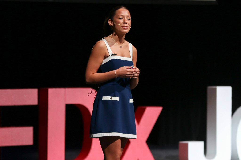 photo of girl on stage with her hands togther