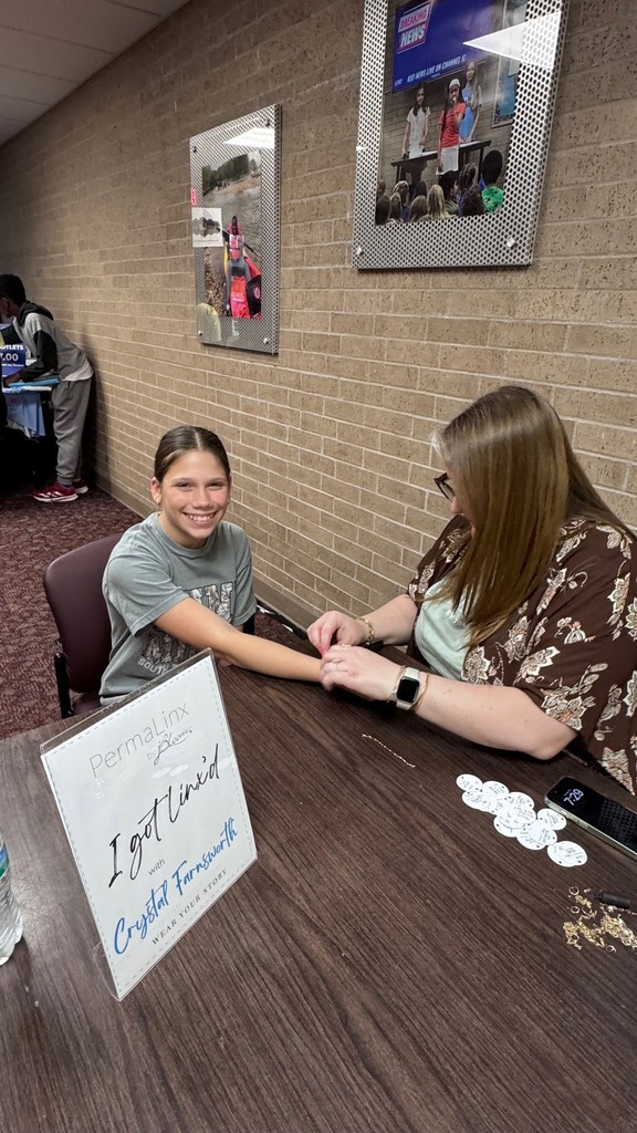 student getting permanent bracelet at the Celebration of learning