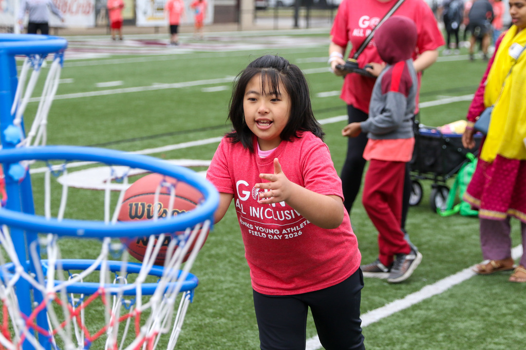 girl throwing a basketball into a hoop