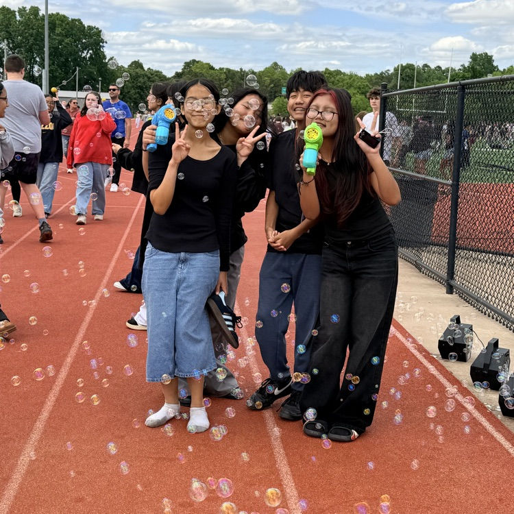 students holding bubble wands 