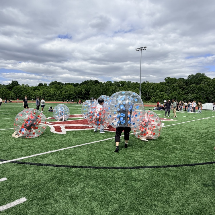 students playing inflatable soccer 