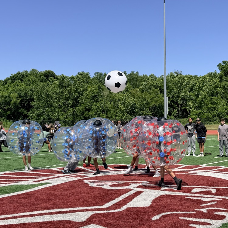 students playing inflatable soccer 