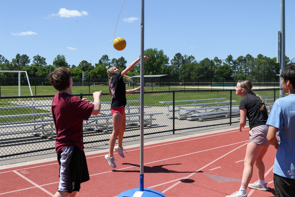 girl jumping to hit the ball in tetherball 
