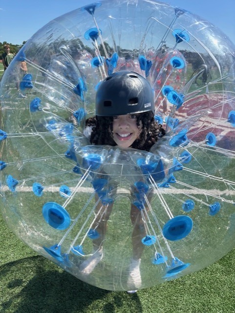 student in helmet in inflatable 