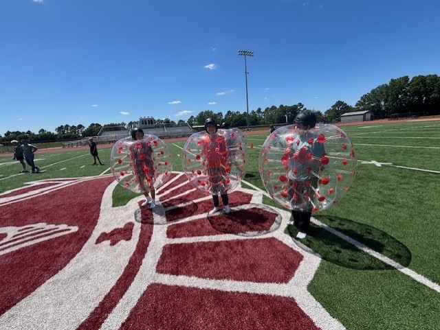 3 students in inflatable soccer 