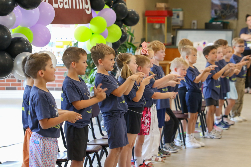 side view of the students standing and singing a song