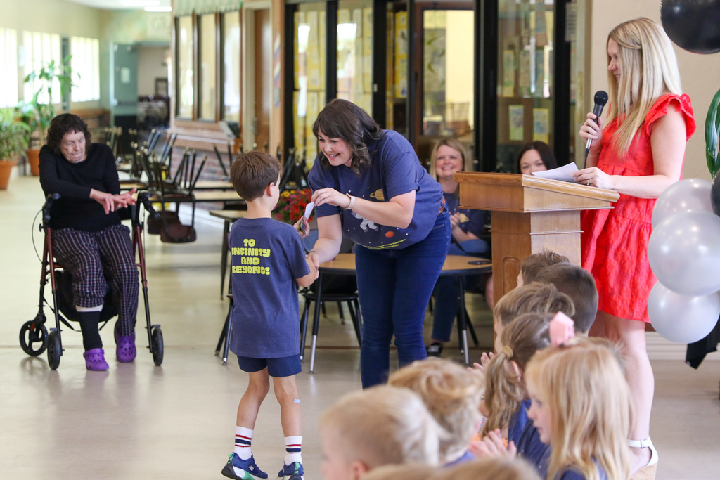 little boy getting his certificate from his teacher