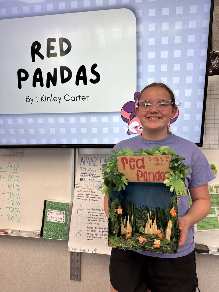 student holding  diorama