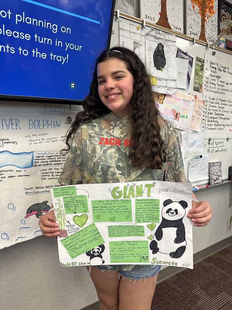 student holding poster