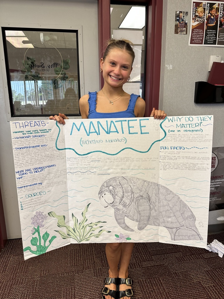 student holding poster