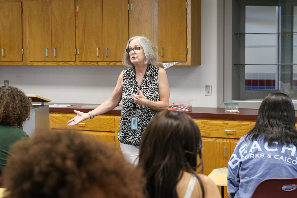 ms. cox teaching the lesson at the front of the classroom