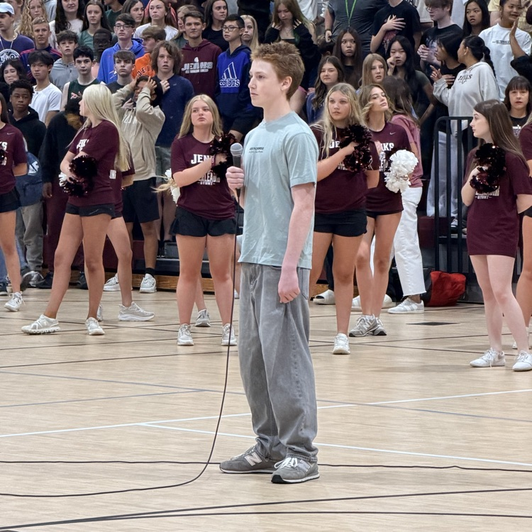 student singing national anthem 