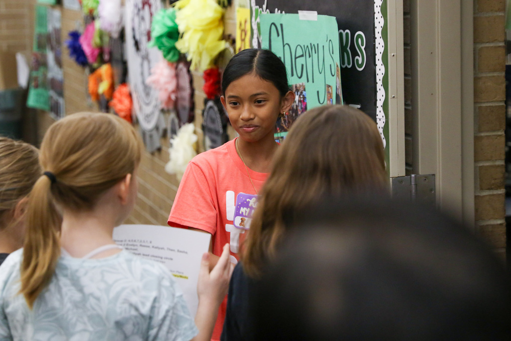 girl smiling while giving a speech at a tour stop